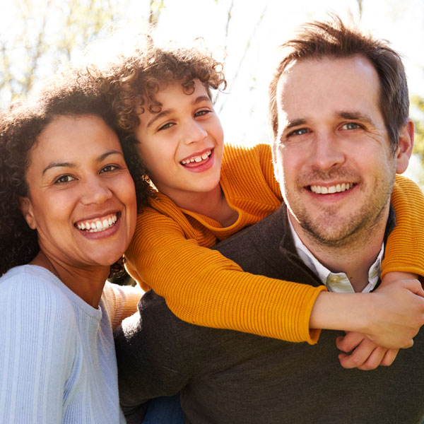 Family smiling together after a visit to Livonia Dentistry